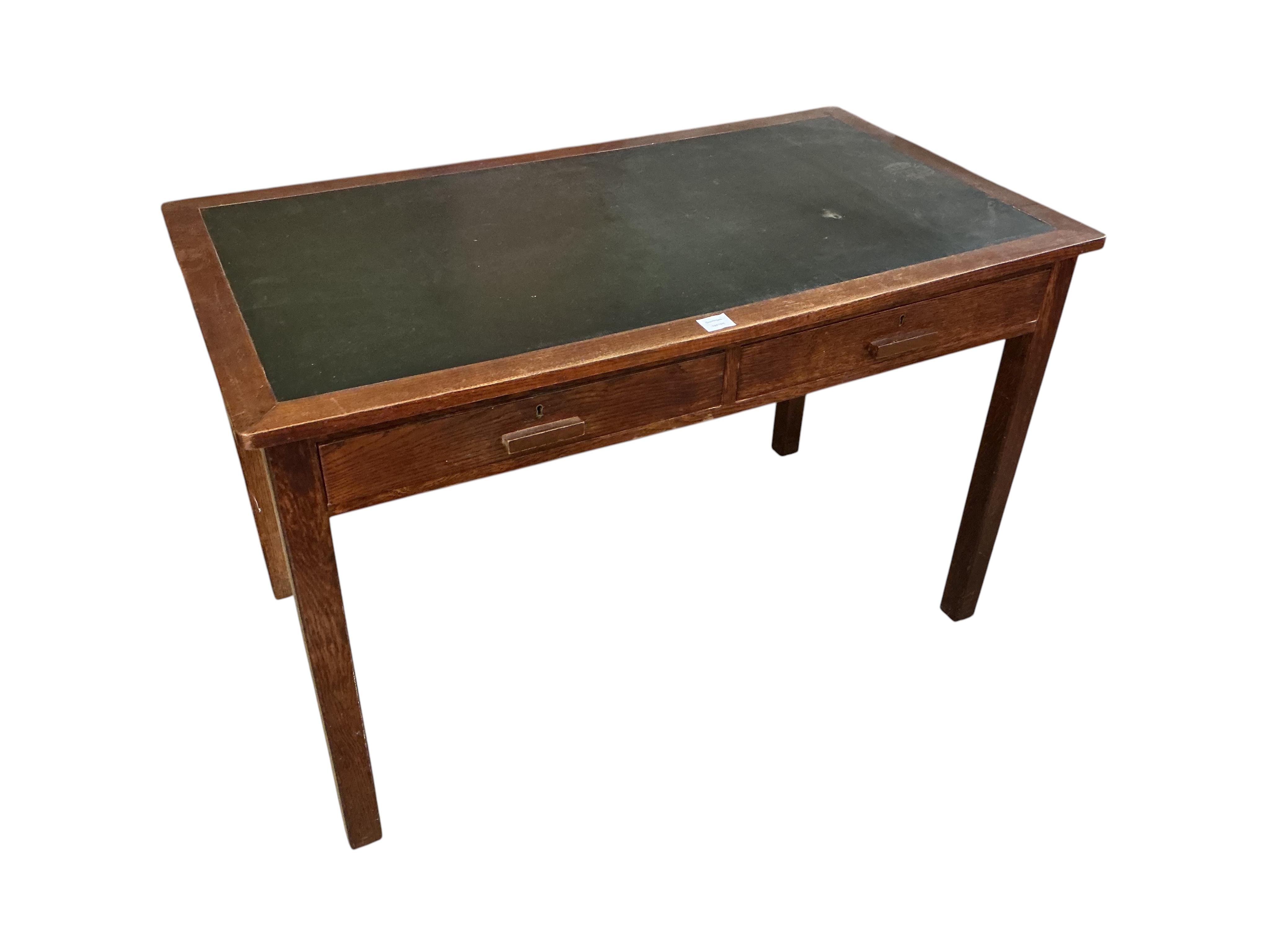 A 1920's oak two drawer writing table, A H Parker retailers, width 122cm, depth 69cm, height 77cm